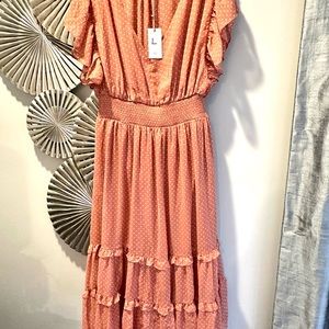 Blush polka dot dress with pretty ruffles.